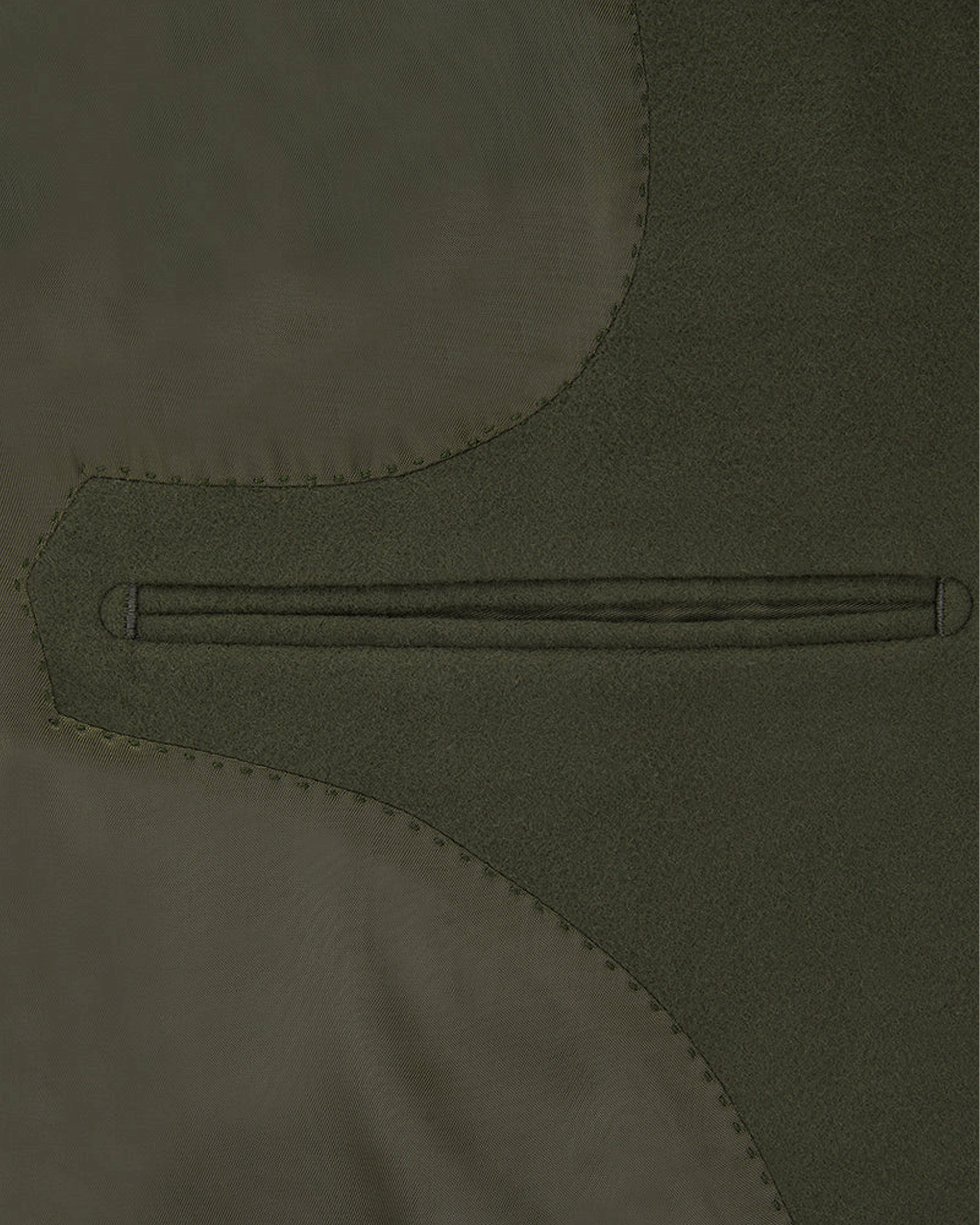 A close up of the inside lining and pocket of an olive green moleskin fabric wasitcoat