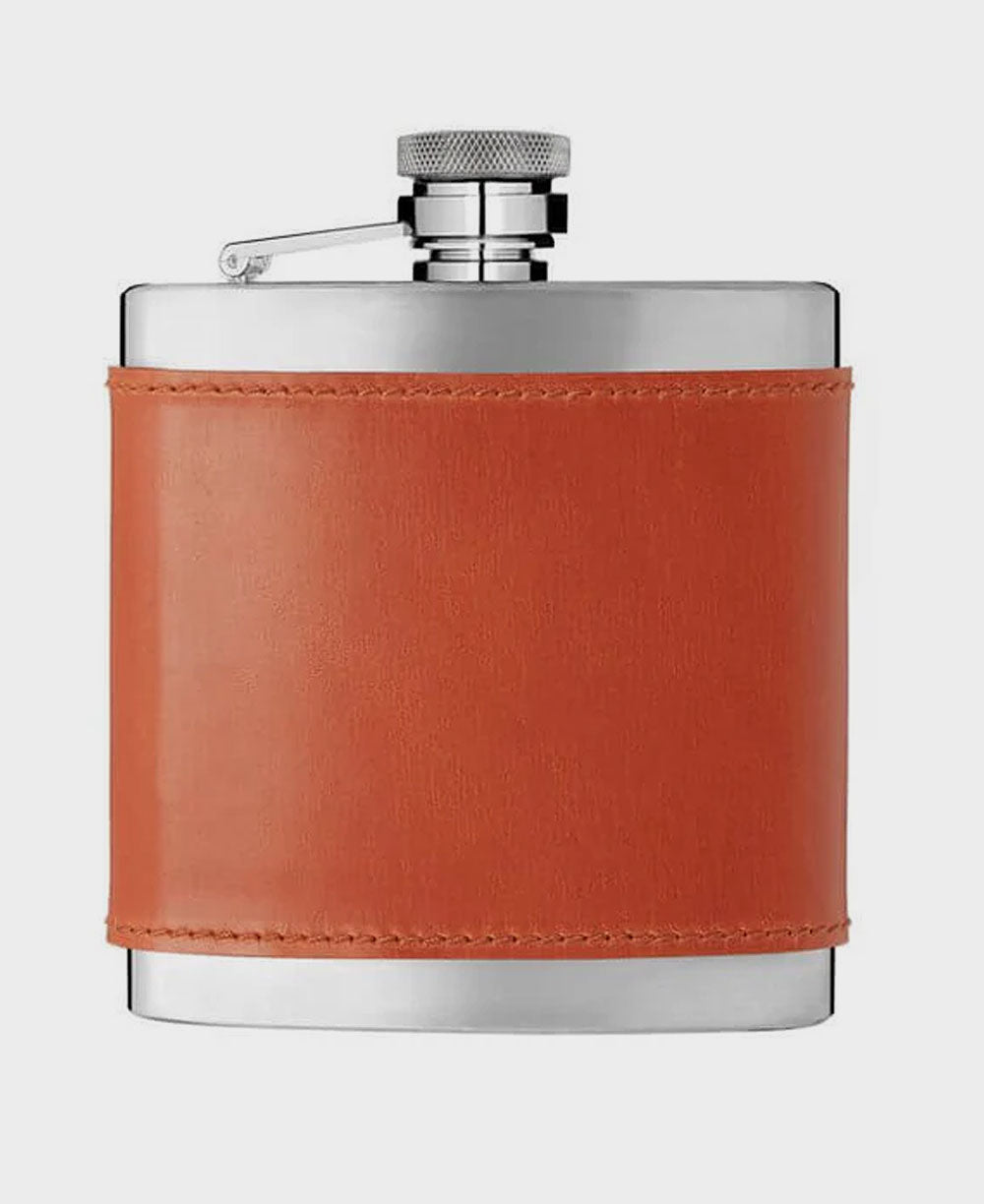 Flask with orange leather wrap and silver cap on a white background