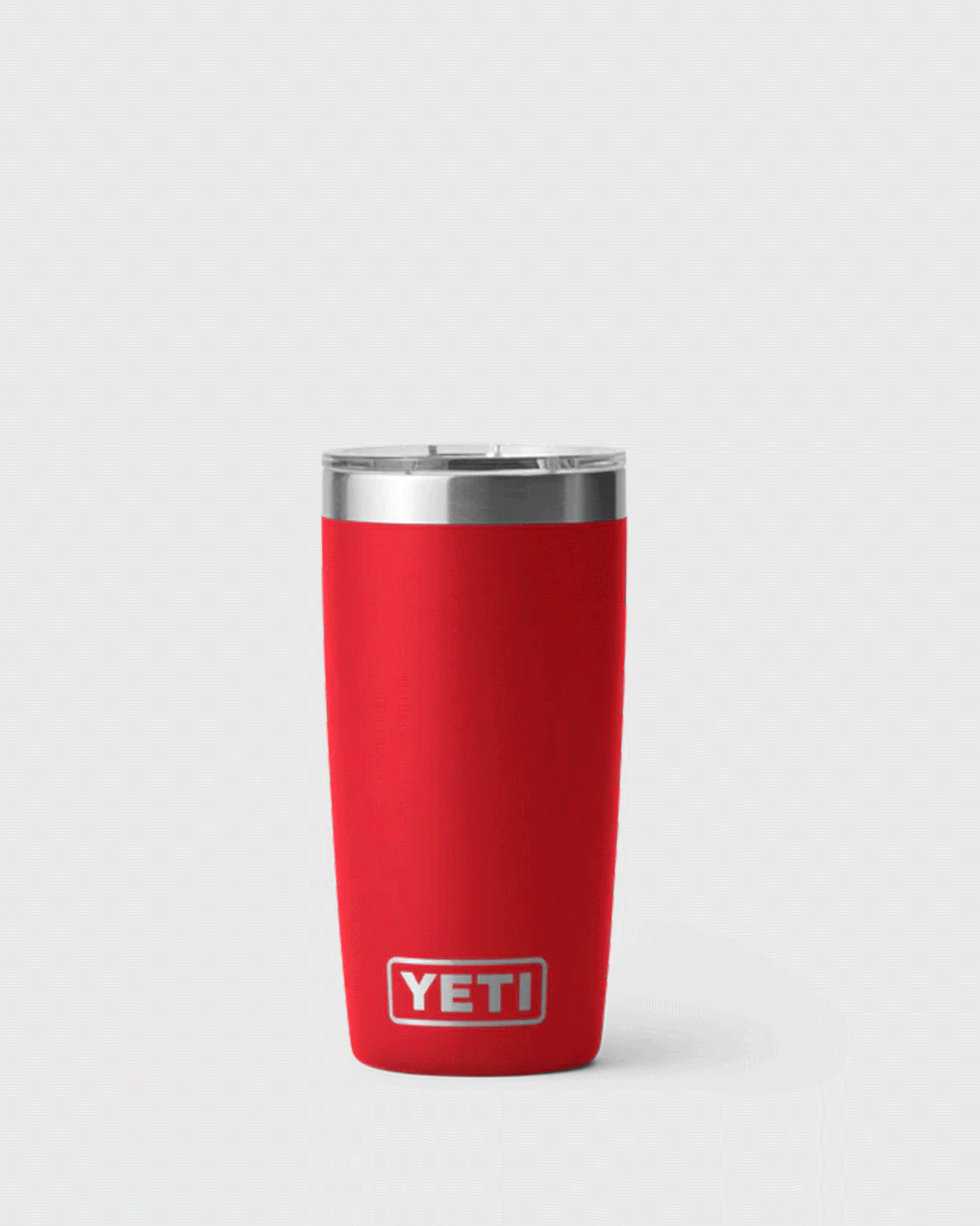 Bright red 'Rescue Red' YETI vacuum-insulated stainless steel tumbler with clear lid and tapered design.