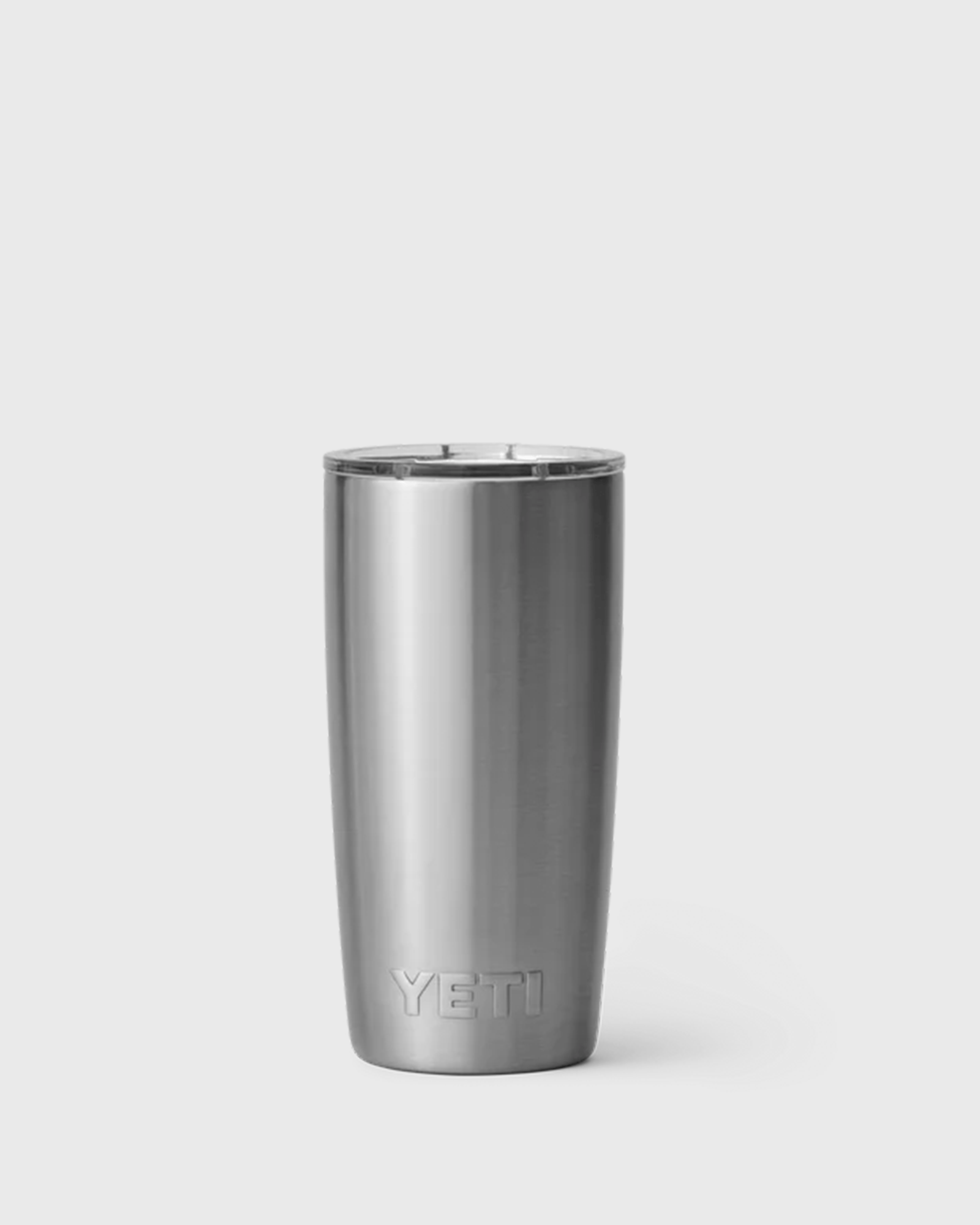 Stainless steel YETI vacuum-insulated stainless steel tumbler with clear lid and tapered design.