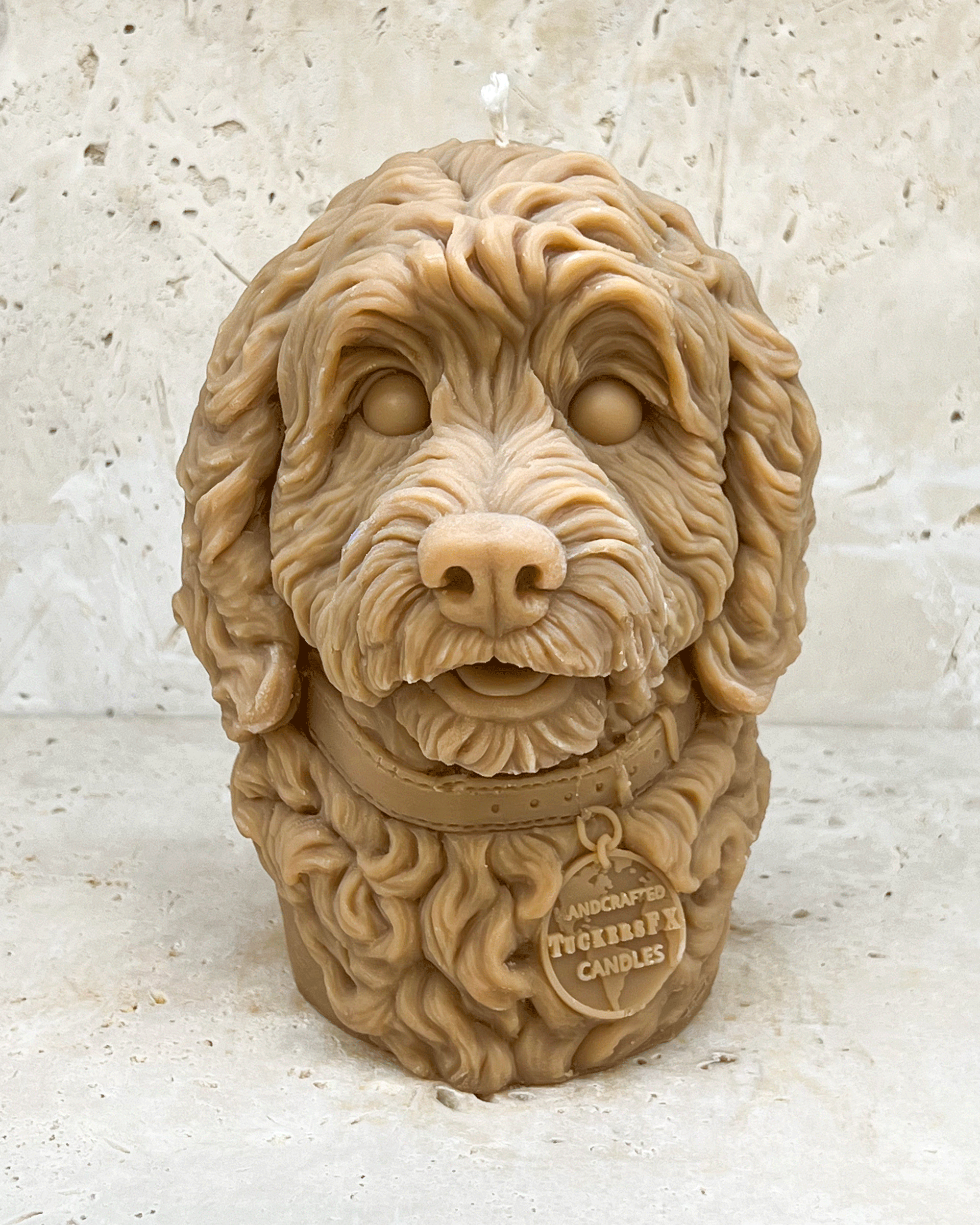 A golden coloured Cockerpoo dog head moulded candle 