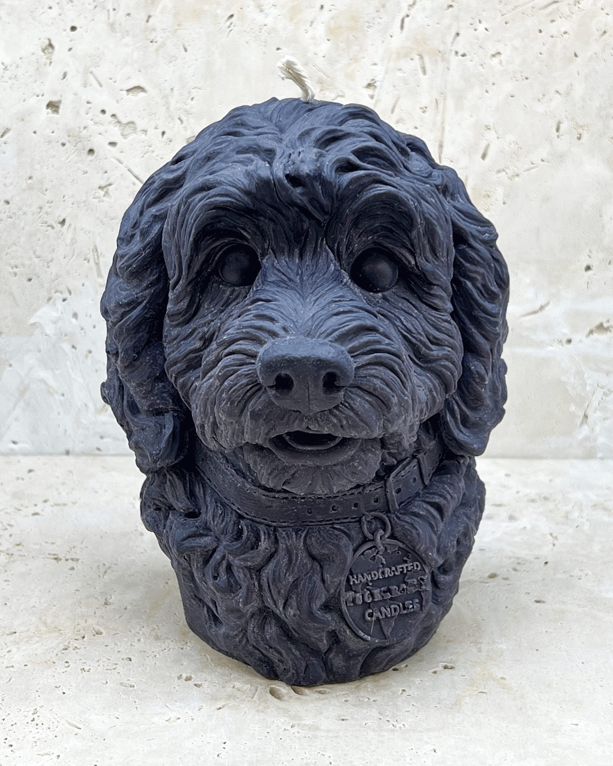 A black Cockerpoo dog head moulded candle 