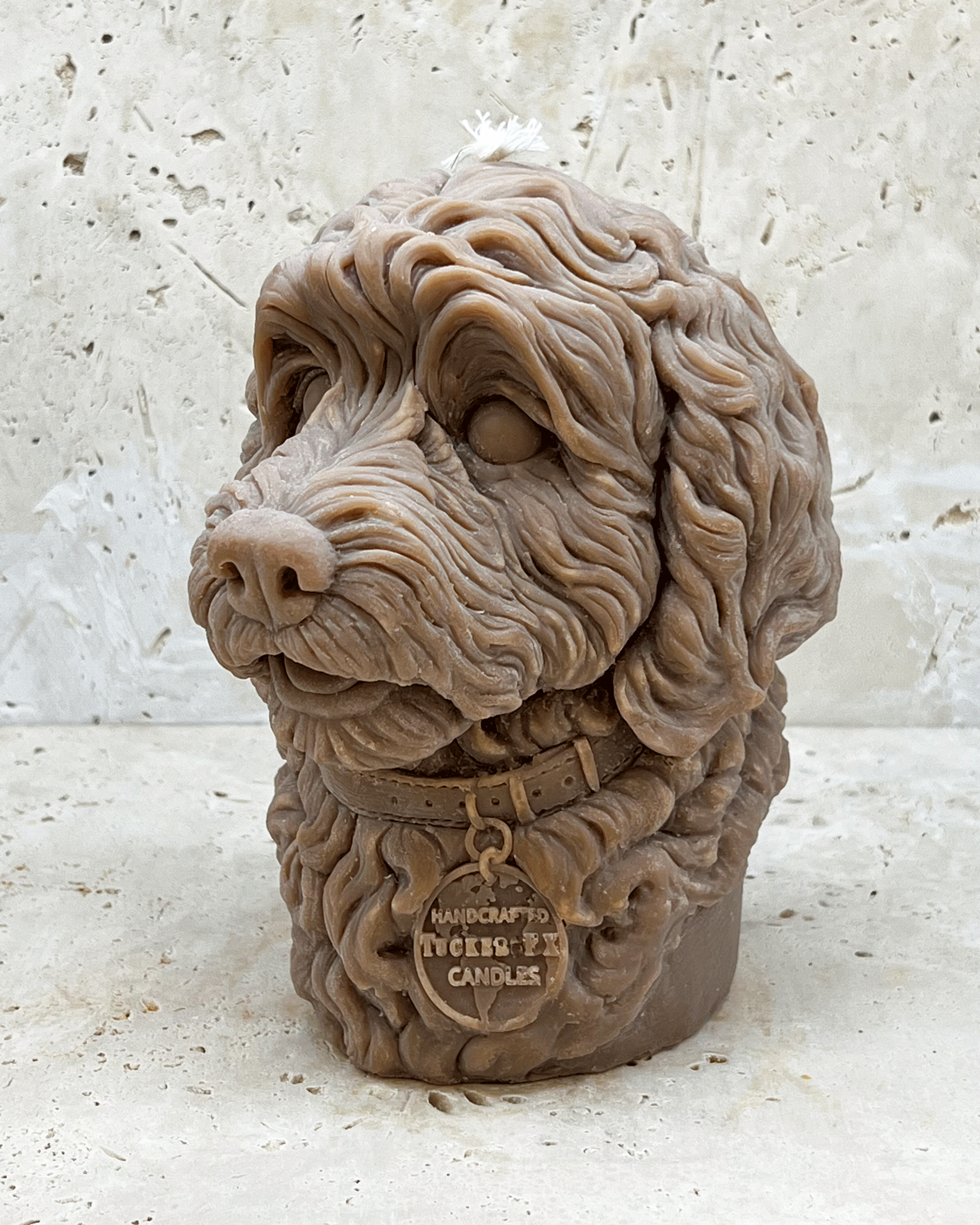 A light brown Cockerpoo dog head moulded candle side view
