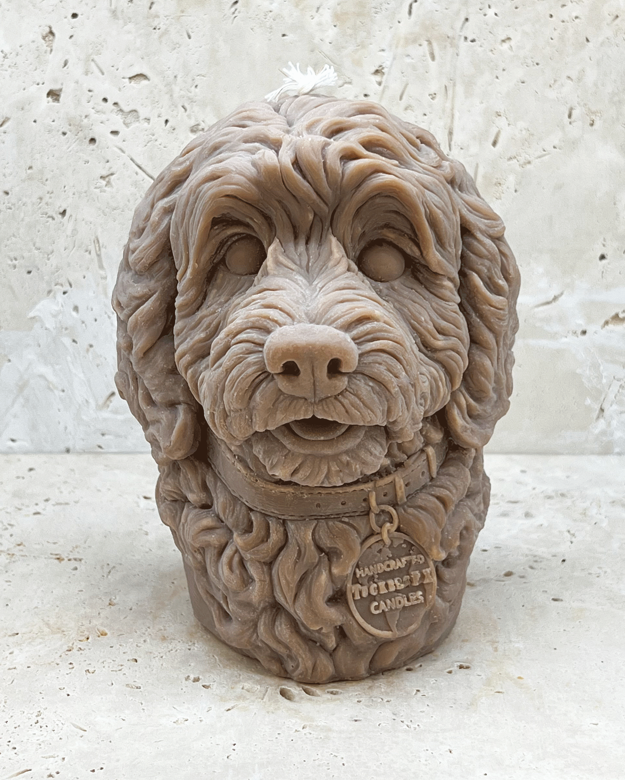 A light brown Cockerpoo dog head moulded candle 